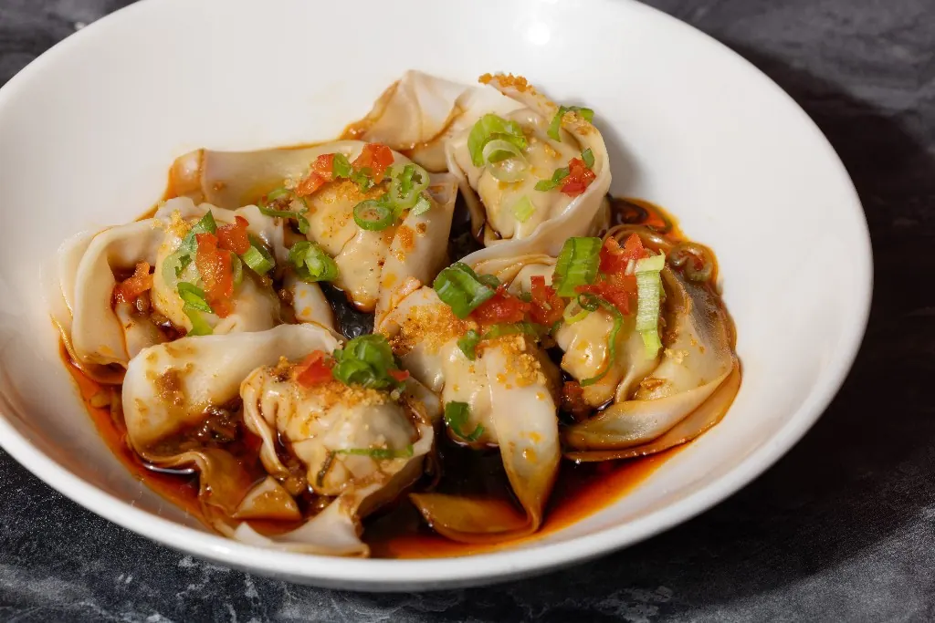 Wontons in chili oil with scallion and garlic