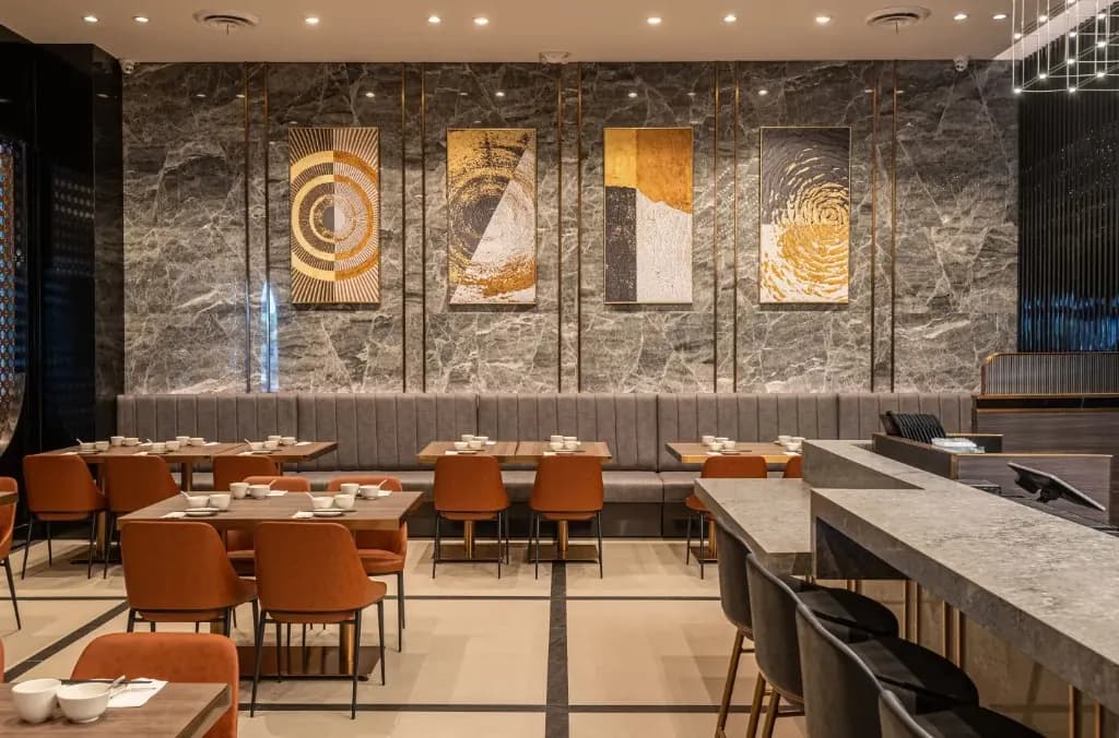 The dining room, with marble walls and orange chairs