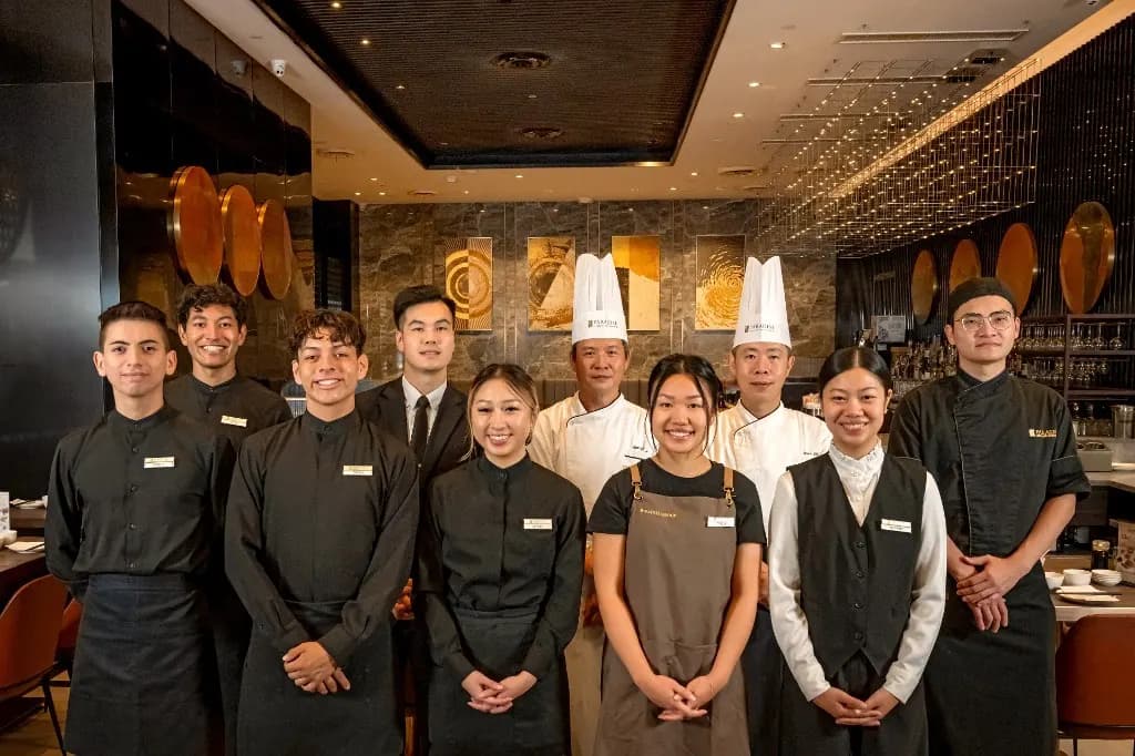 The Paradise Dynasty team standing together in the dining room