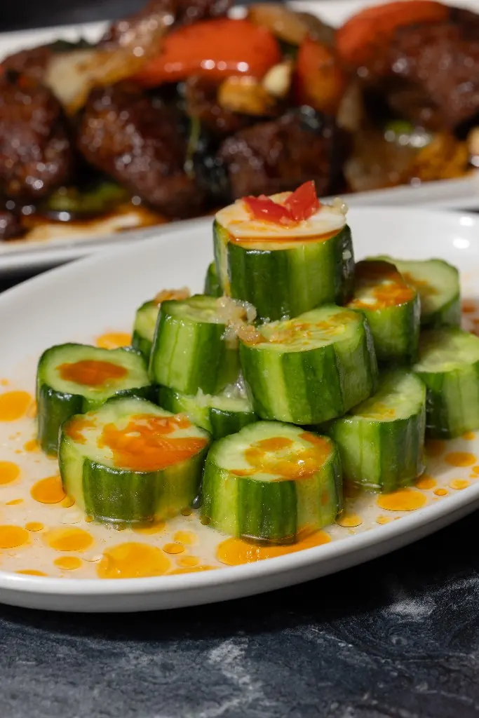 Sliced cucumber stacked with chili oil