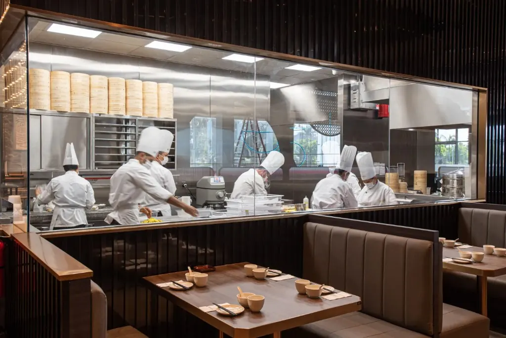 Chefs working in the open kitchen behind the dining booths